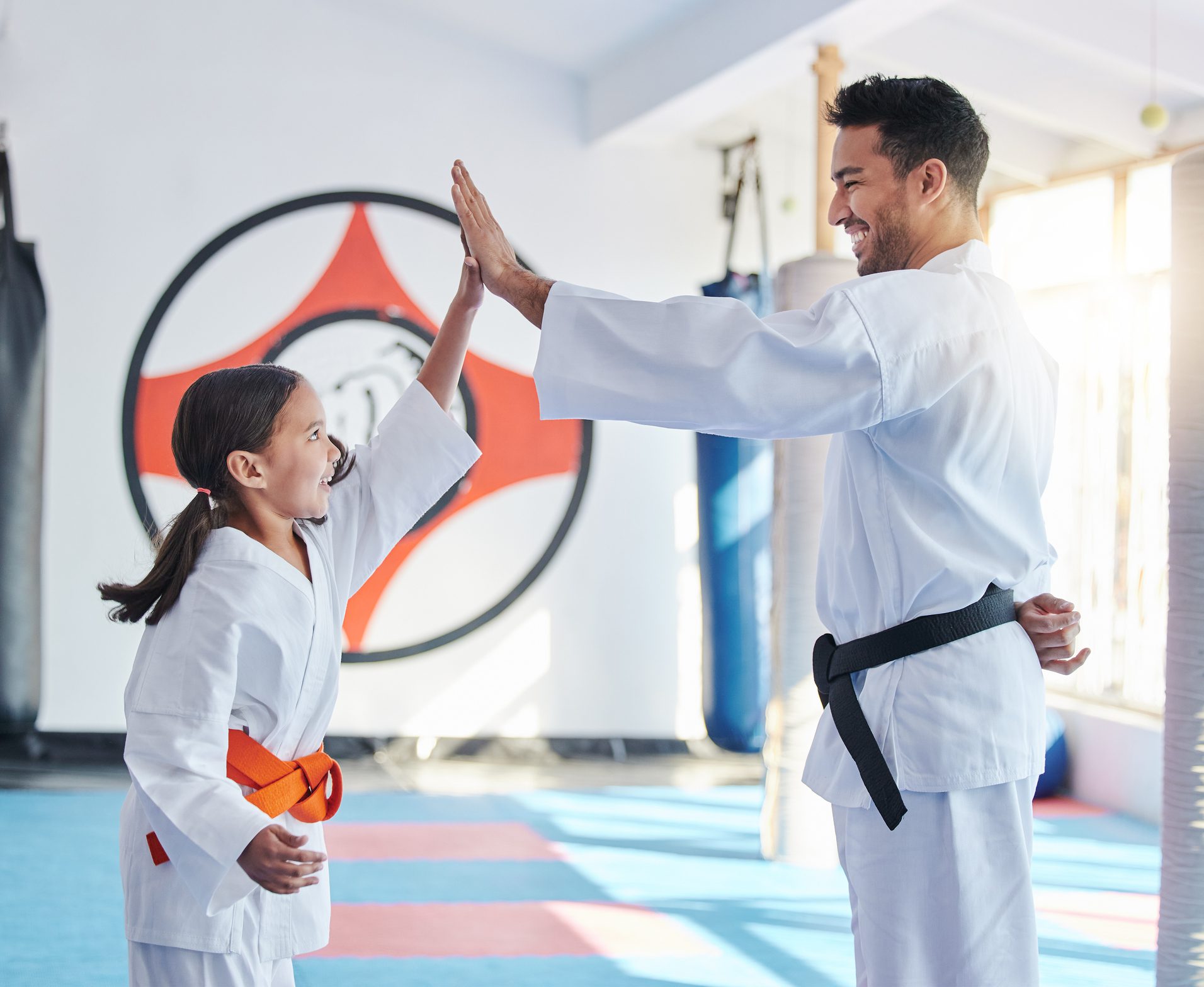 Teacher and student celebrating in dojo