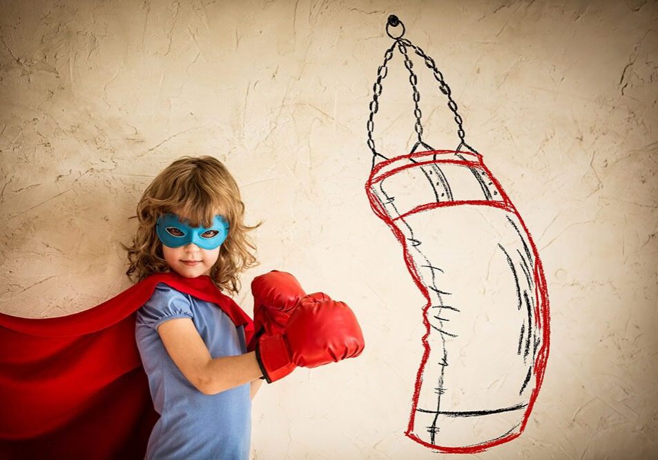 Kid in cape and mask punching
